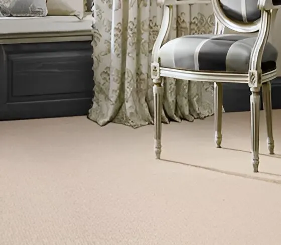 Bolero cream wool carpet in a formal sitting room with a silver-framed chair